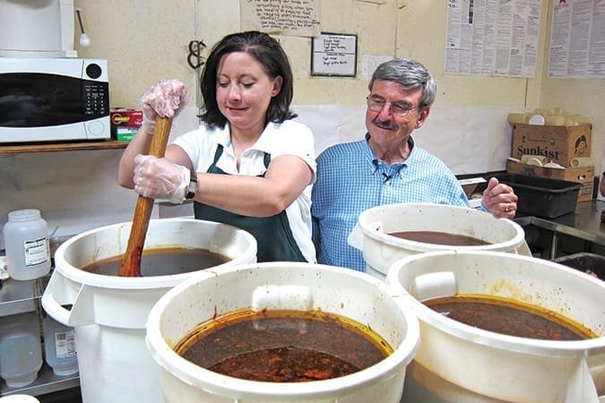 Lisa Proffitt Peters and her father Larry Proffitt, owners of Ridgewood Barbecue, make sauce from a secret family recipe.