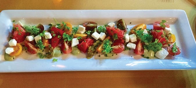 Locally grown tomatoes, in a variety of colors, are combined to make this summertime salad at Rain.