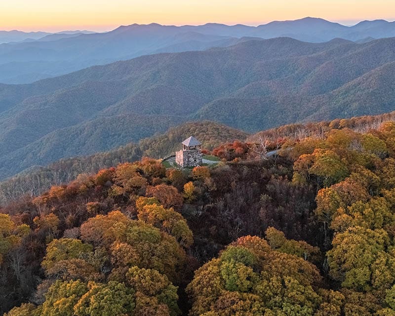 Wayah Bald in North Carolina’s Nantahala National Forest. From the photographer: “I always feel so lucky to catch a glowing sunset high up in the mountains, and standing at the tower in peak autumnal colors can’t be beat.” Photo by Trevor Bamford